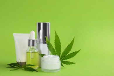 Photo of Composition with CBD oil, THC tincture and hemp leaves on light green background. Space for text
