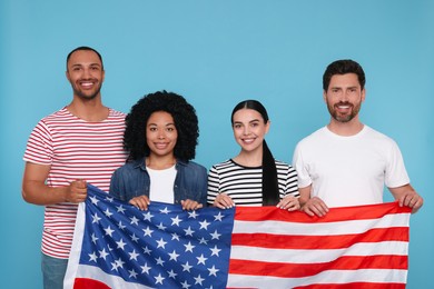 Photo of 4th of July - Independence Day of USA. Happy friends with American flag on light blue background