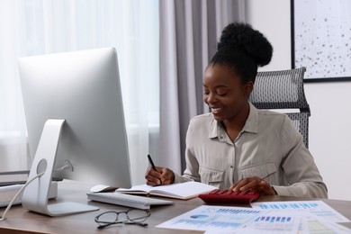 Professional accountant working at wooden desk in office