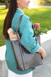 Woman with leather shopper bag in park, closeup