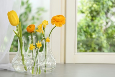 Beautiful fresh spring flowers on window sill indoors