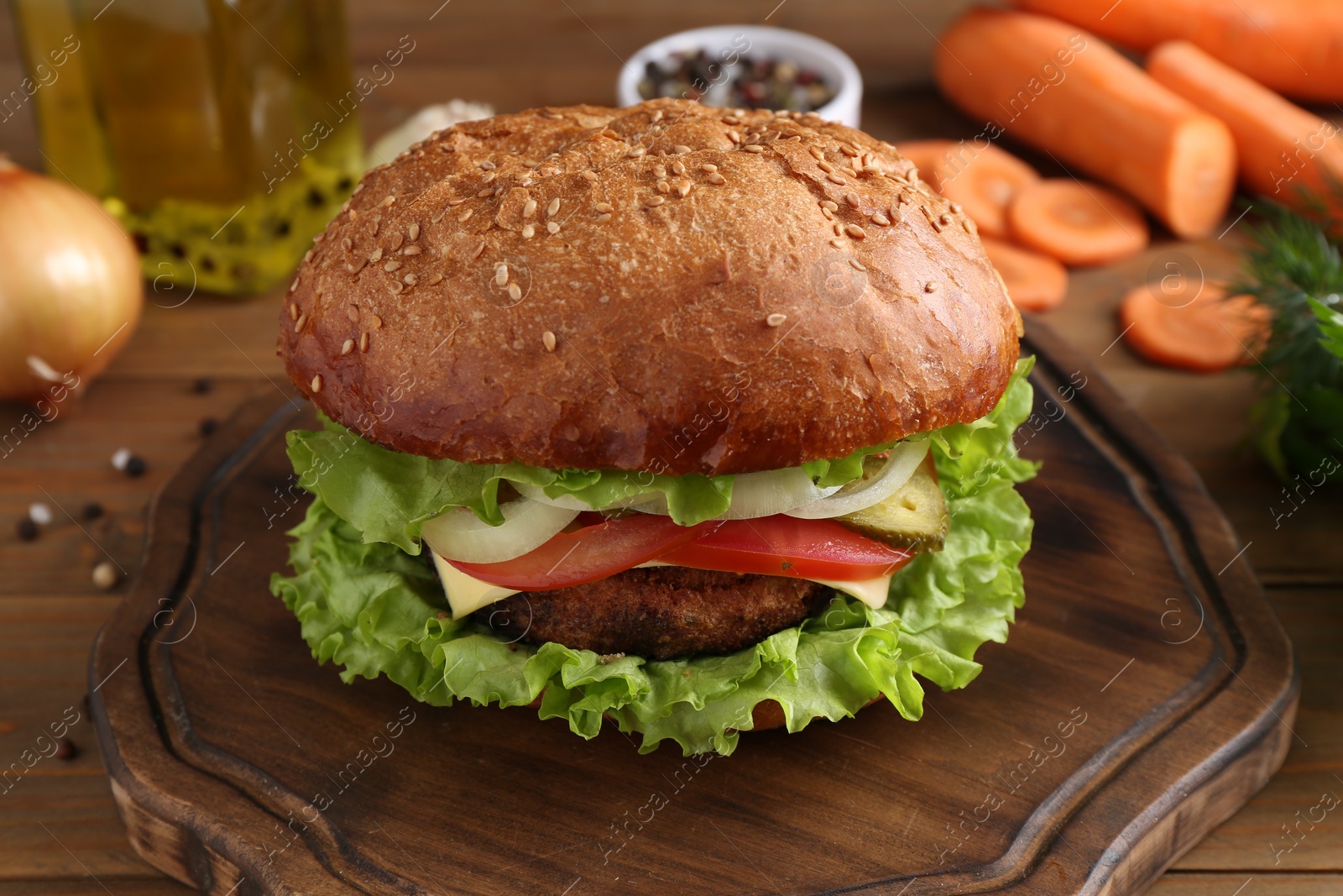 Photo of Delicious vegetarian burger served on wooden table, closeup