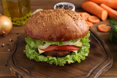 Photo of Delicious vegetarian burger served on wooden table, closeup