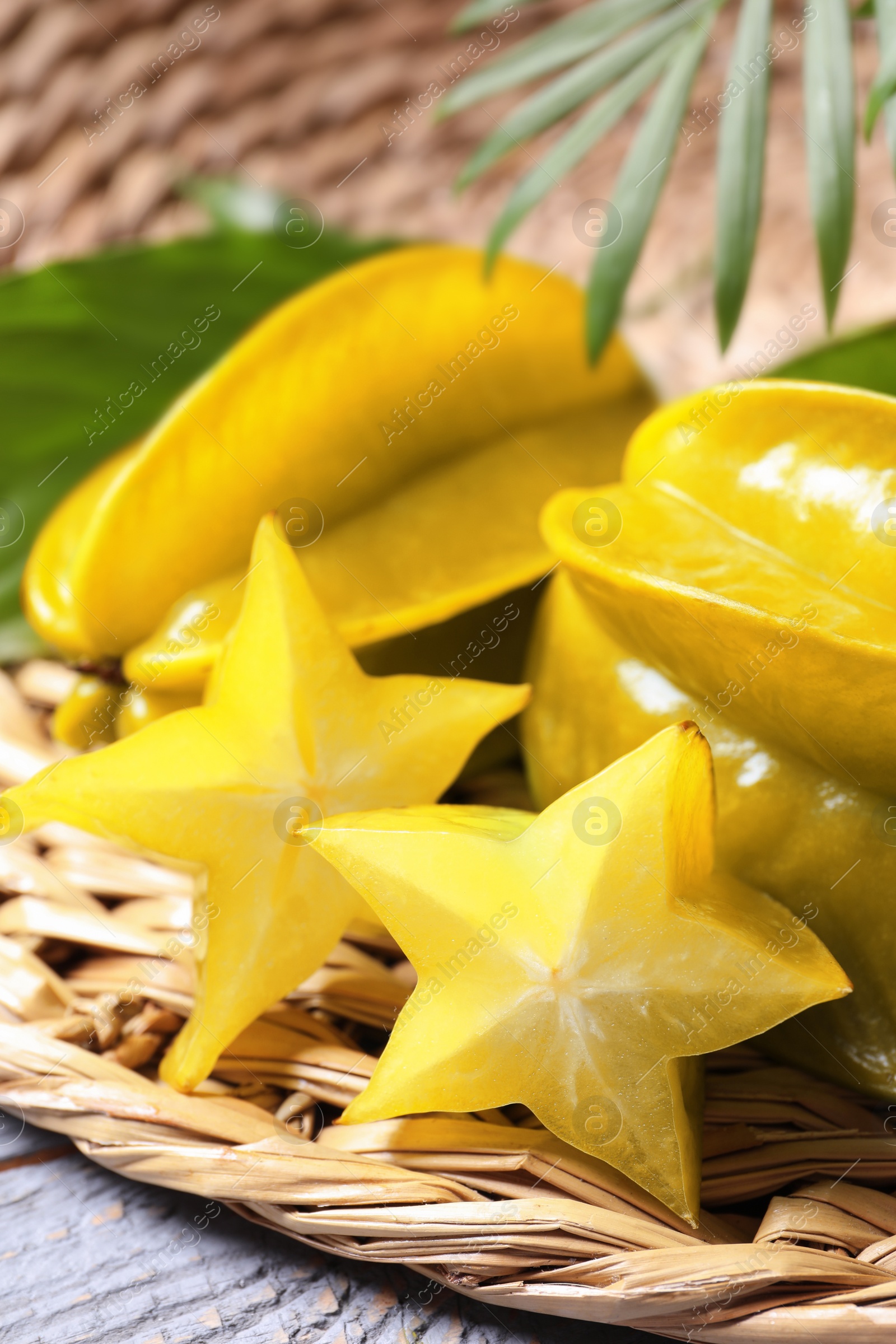 Photo of Delicious carambola fruits on light grey wooden table