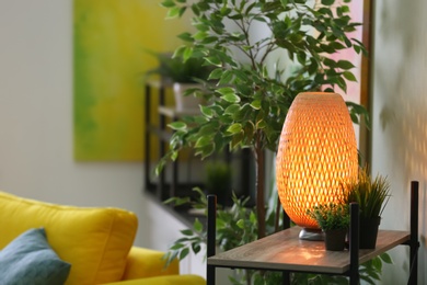Stylish lamp on table in living room. Interior design element