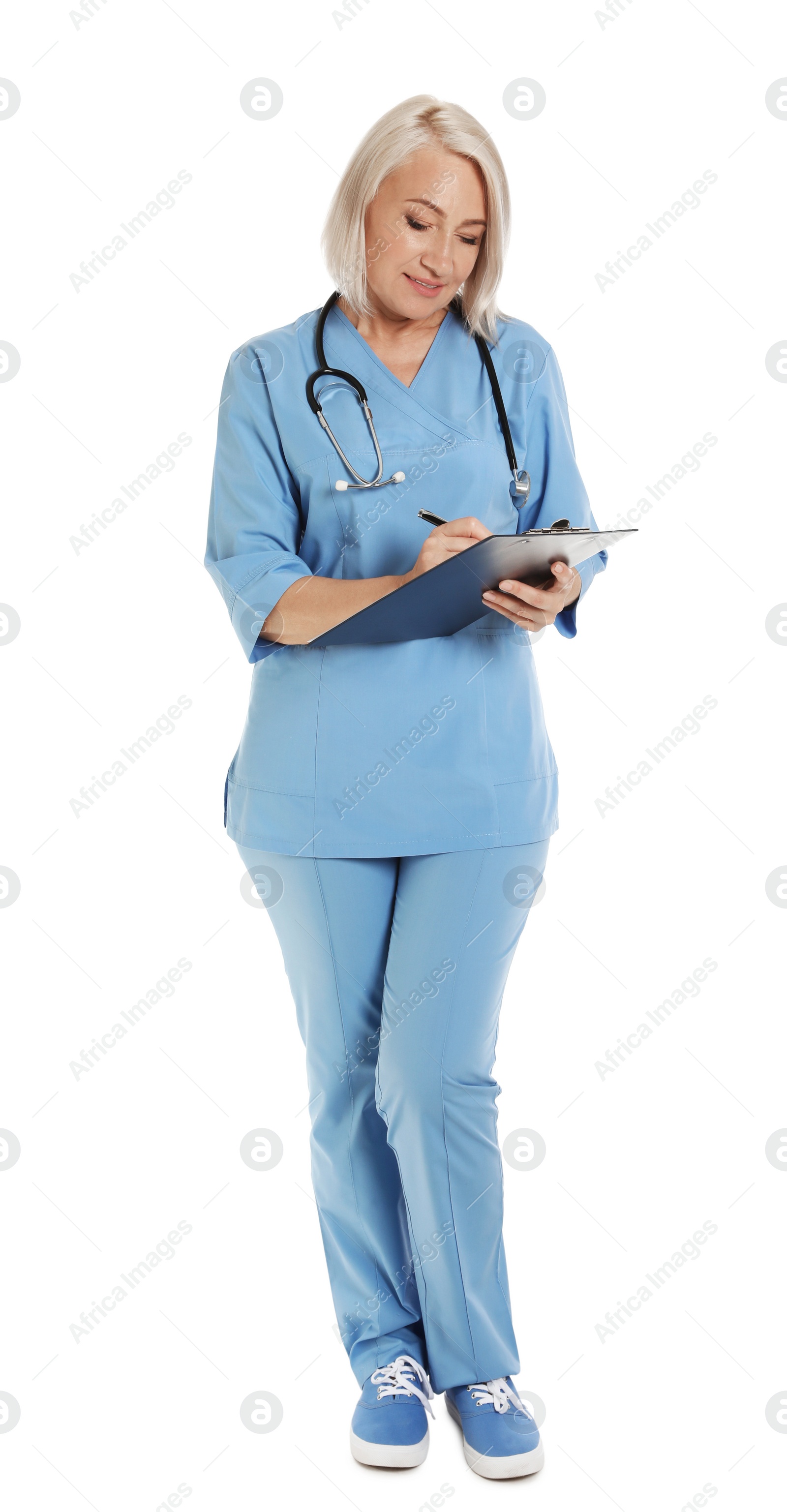 Photo of Full length portrait of female doctor in scrubs with clipboard isolated on white. Medical staff