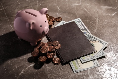 Pension certificate, American money and piggy bank on marble table