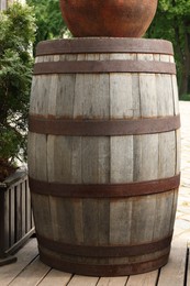 Traditional wooden barrel on street outdoors. Wine making
