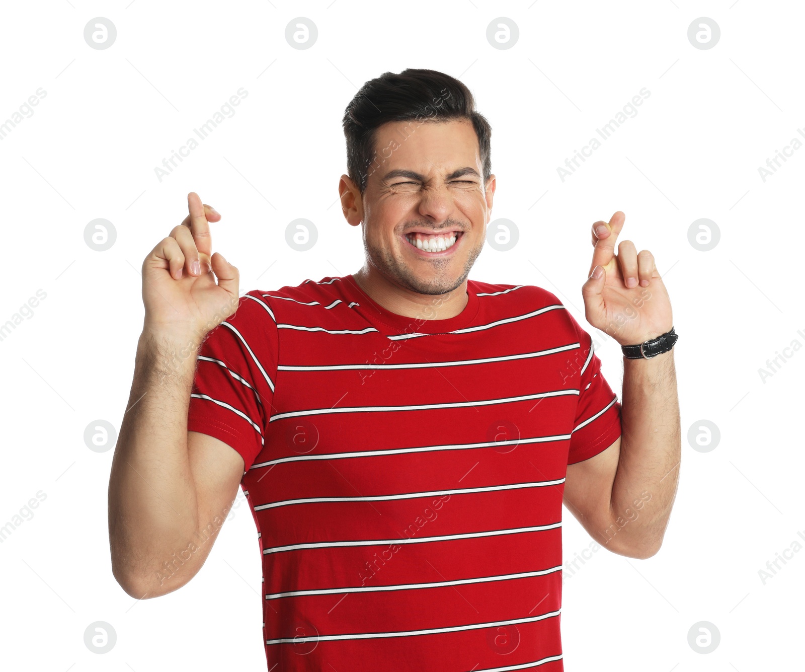 Photo of Man with crossed fingers on white background. Superstition concept