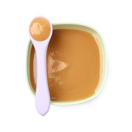 Tasty baby food in bowl and spoon isolated on white, top view