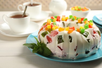 Delicious broken glass jelly cake on white wooden table