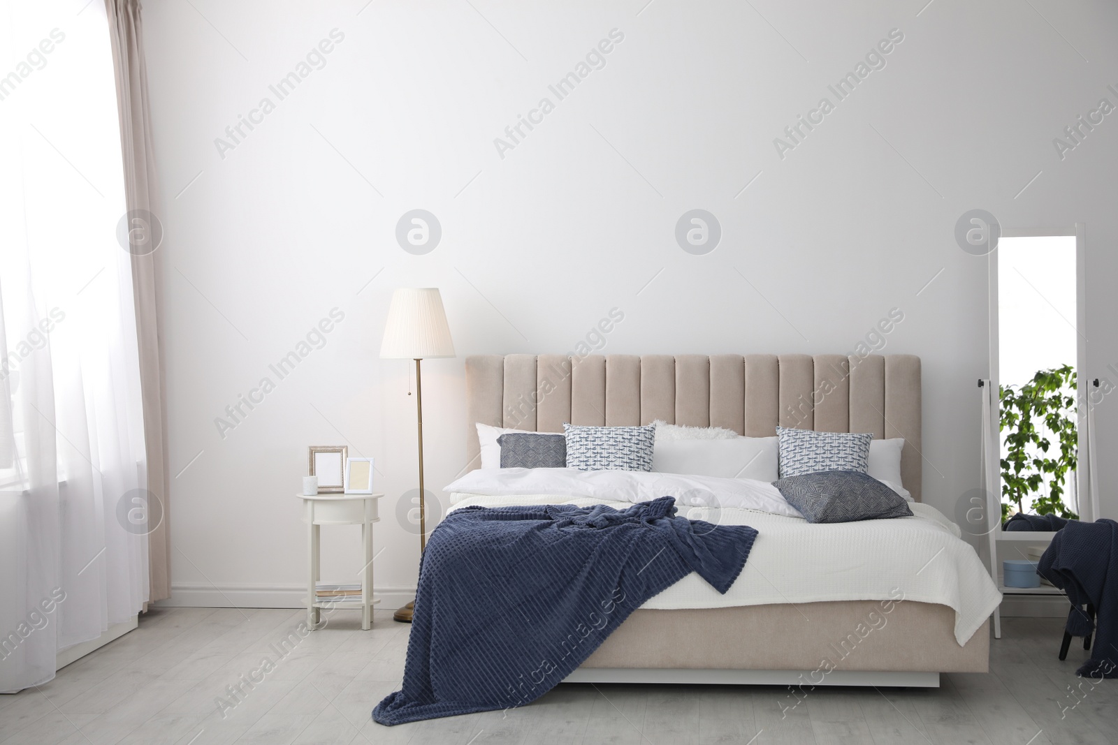 Photo of Comfortable bed with pillows in room. Stylish interior design