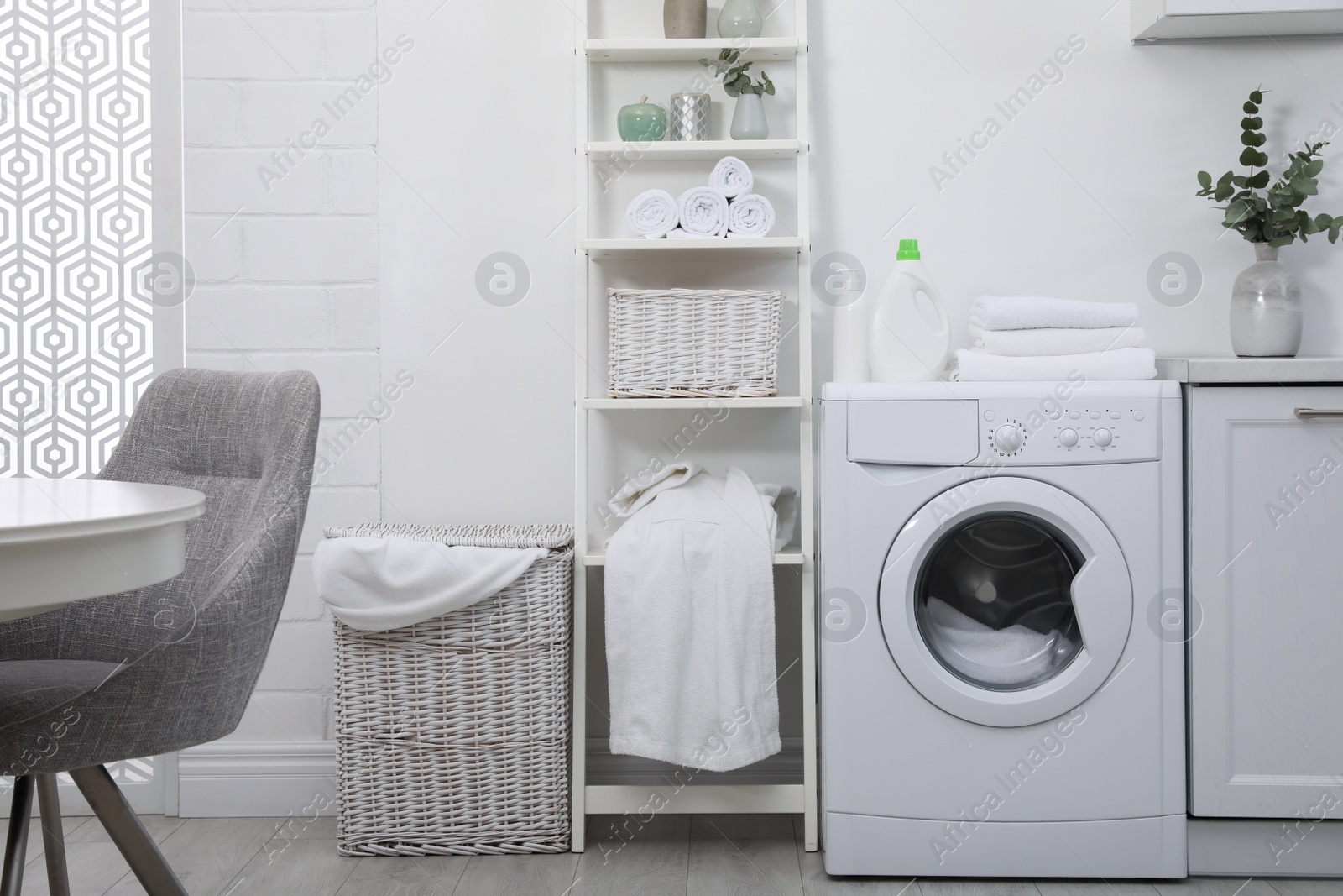 Photo of Kitchen interior with washing machine and stylish furniture