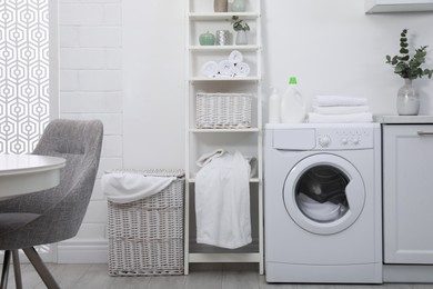 Photo of Kitchen interior with washing machine and stylish furniture