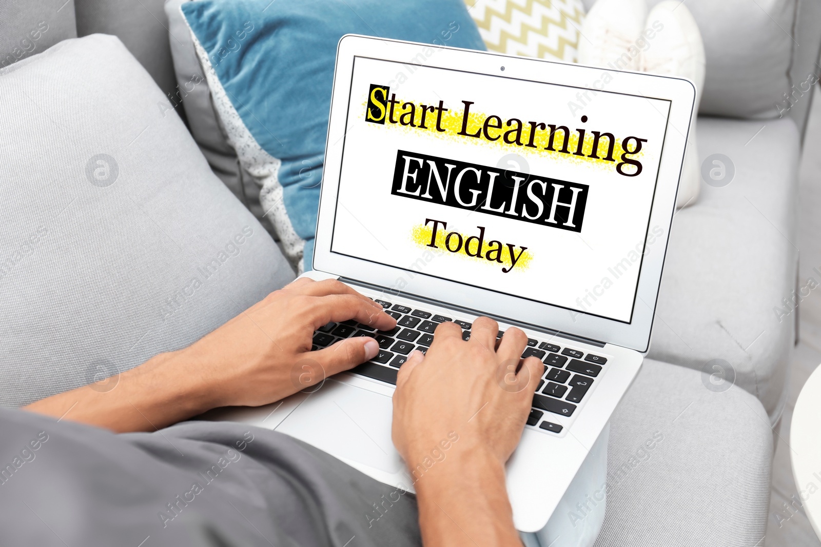 Image of Man using laptop for online English learning at home