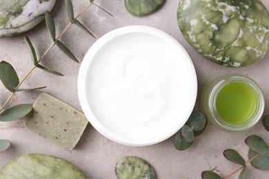 Photo of Flat lay composition with jars of cream on light textured table. Body care products