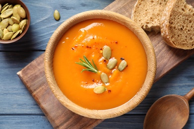 Photo of Flat lay composition with bowl of sweet potato soup on table