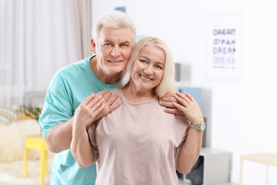 Portrait of adorable mature couple together at home