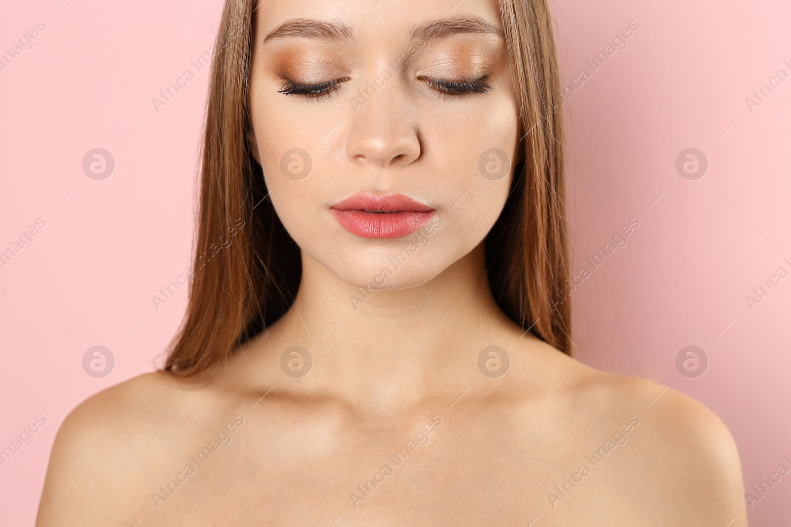 Photo of Portrait of beautiful young woman with natural makeup on color background