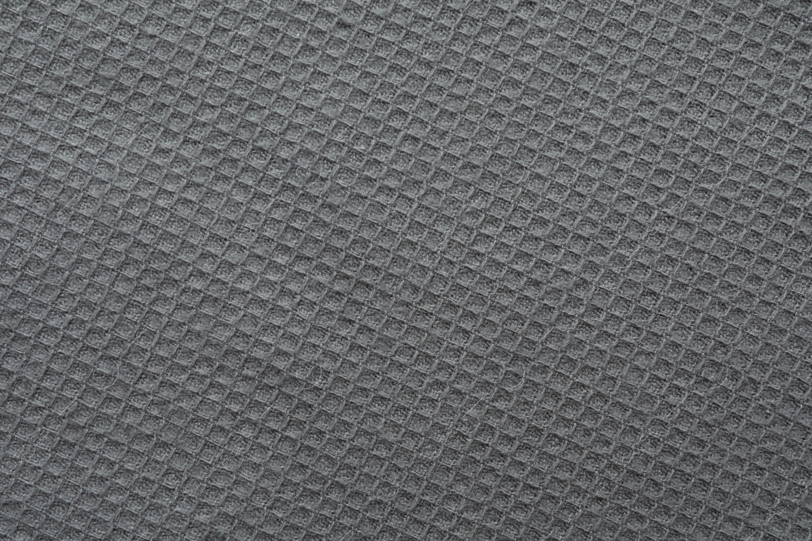 Photo of Texture of grey knitted fabric as background, top view