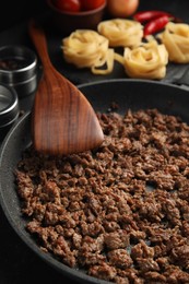 Photo of Fried minced meat on black table, closeup