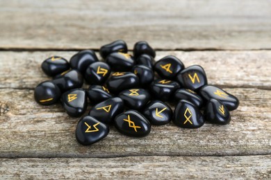 Pile of black rune stones on wooden table