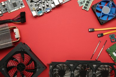 Photo of Frame of graphics card and other computer hardware on red background, flat lay. Space for text