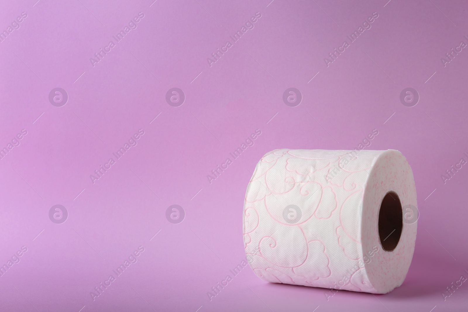 Photo of Roll of toilet paper on color background. Space for text