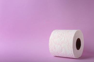 Photo of Roll of toilet paper on color background. Space for text