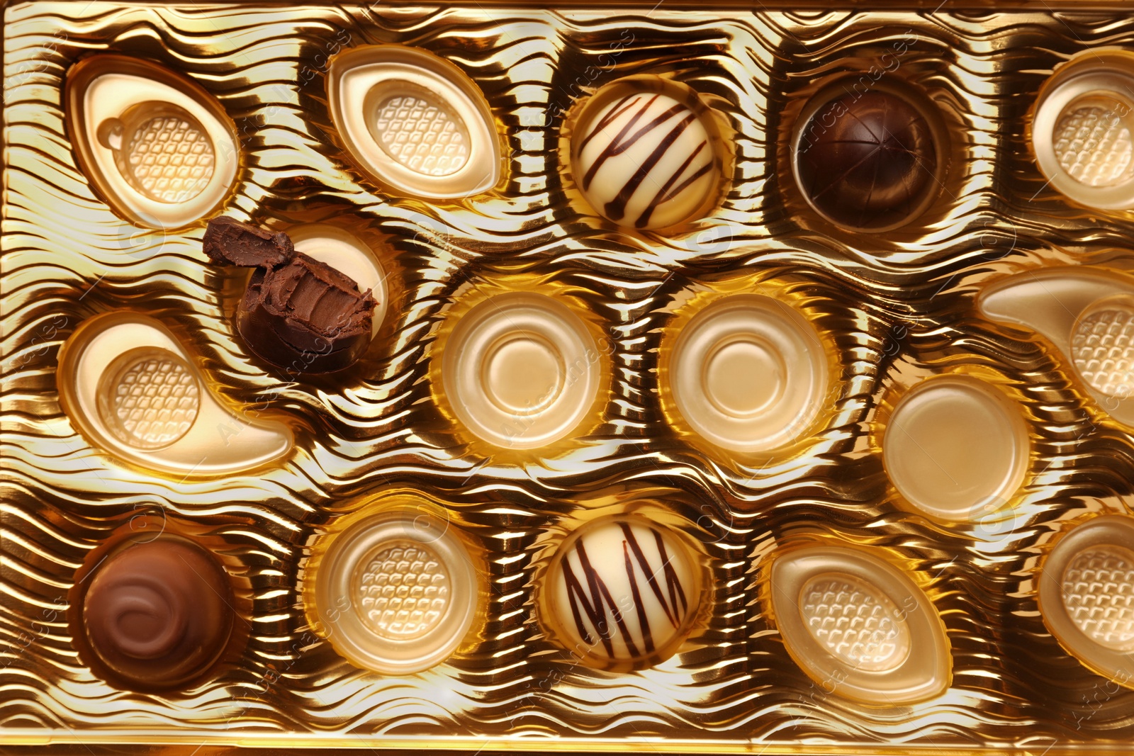 Photo of Partially empty box of chocolate candies as background, top view