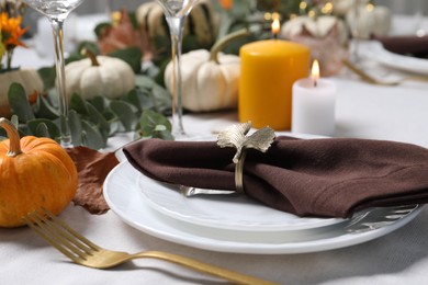 Beautiful autumn table setting with floral decor, closeup