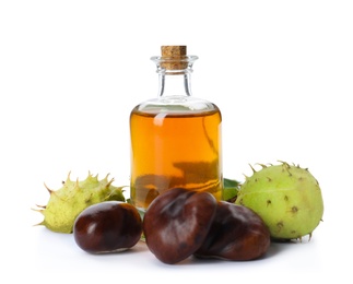 Horse chestnuts and bottle of tincture on white background