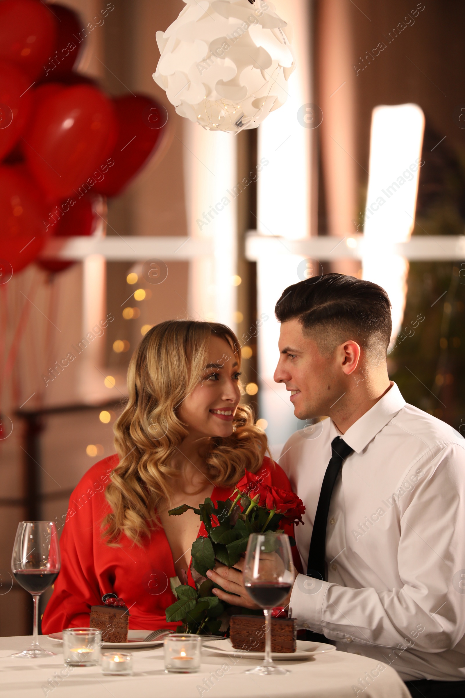 Photo of Lovely couple having romantic dinner on Valentine's day in restaurant