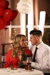 Photo of Lovely couple having romantic dinner on Valentine's day in restaurant