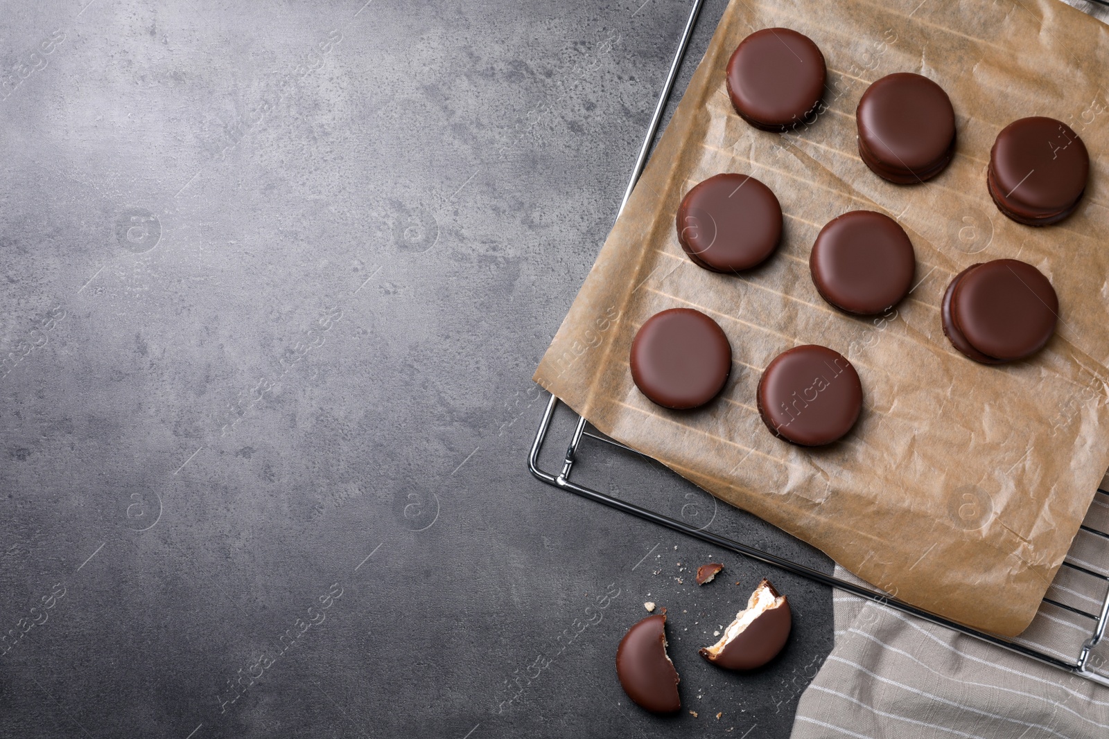 Photo of Tasty choco pies on grey table, flat lay. Space for text