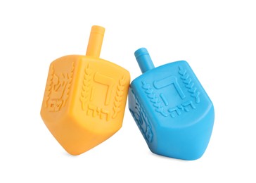 Hanukkah celebration. Colorful dreidels with jewish letters isolated on white
