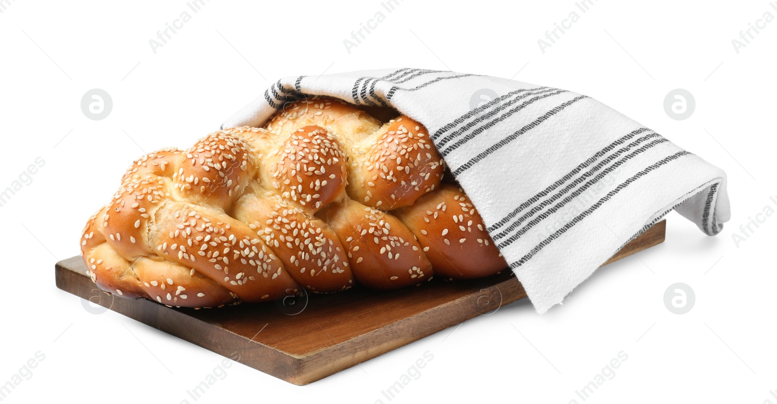 Photo of Homemade braided bread with sesame seeds and napkin isolated on white. Traditional Shabbat challah