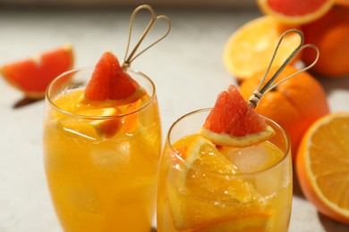 Photo of Delicious orange soda water on light background, closeup