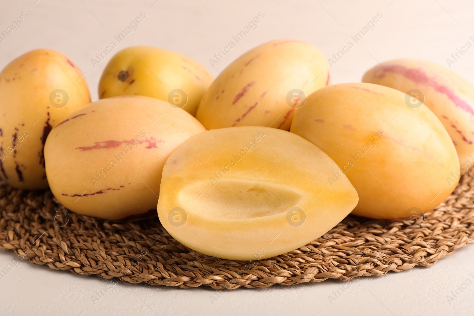 Photo of Fresh ripe pepino melons on white table, closeup