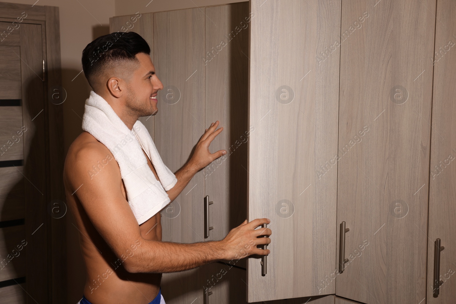 Photo of Handsome man near open locker in changing room