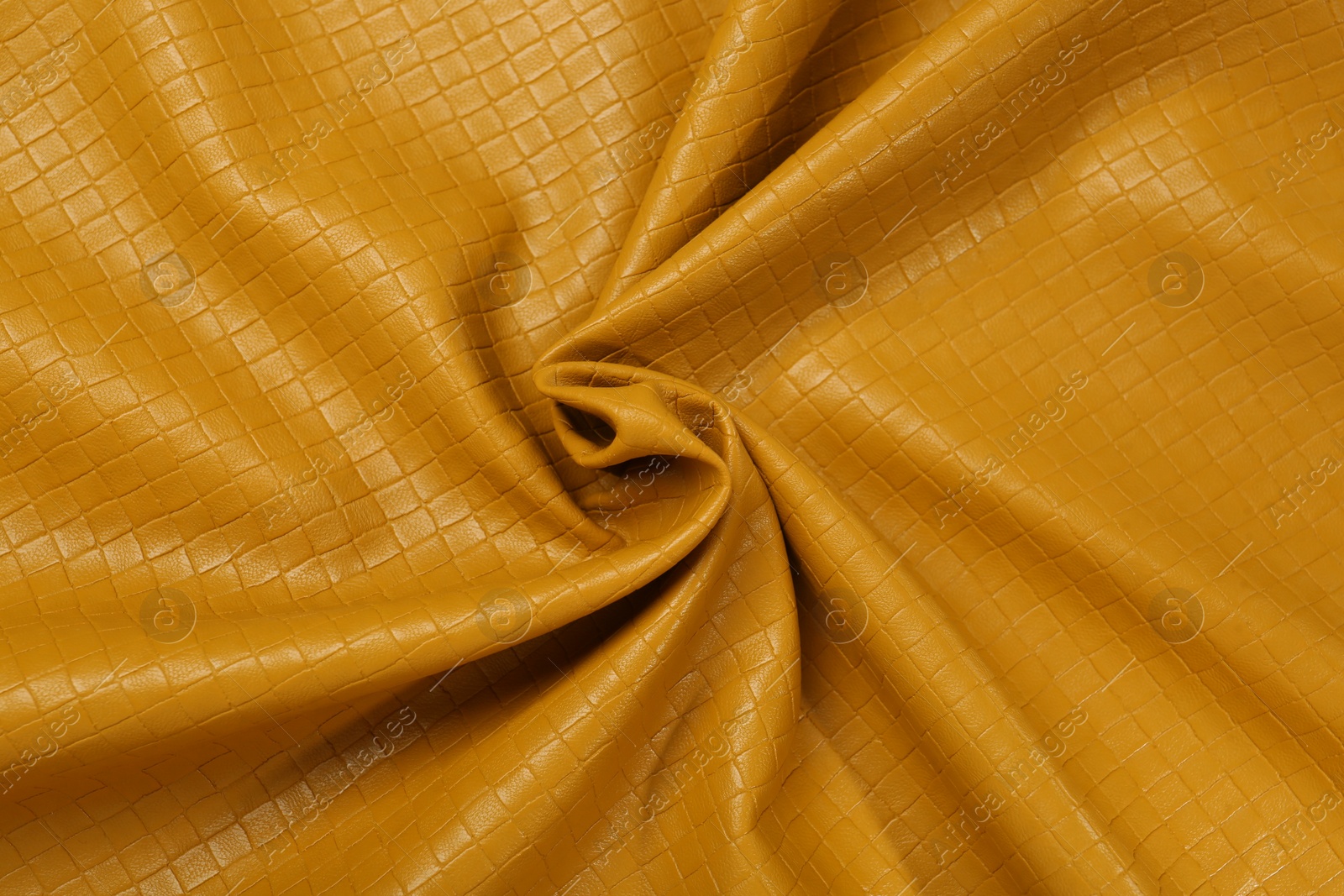 Photo of Beautiful yellow leather as background, top view