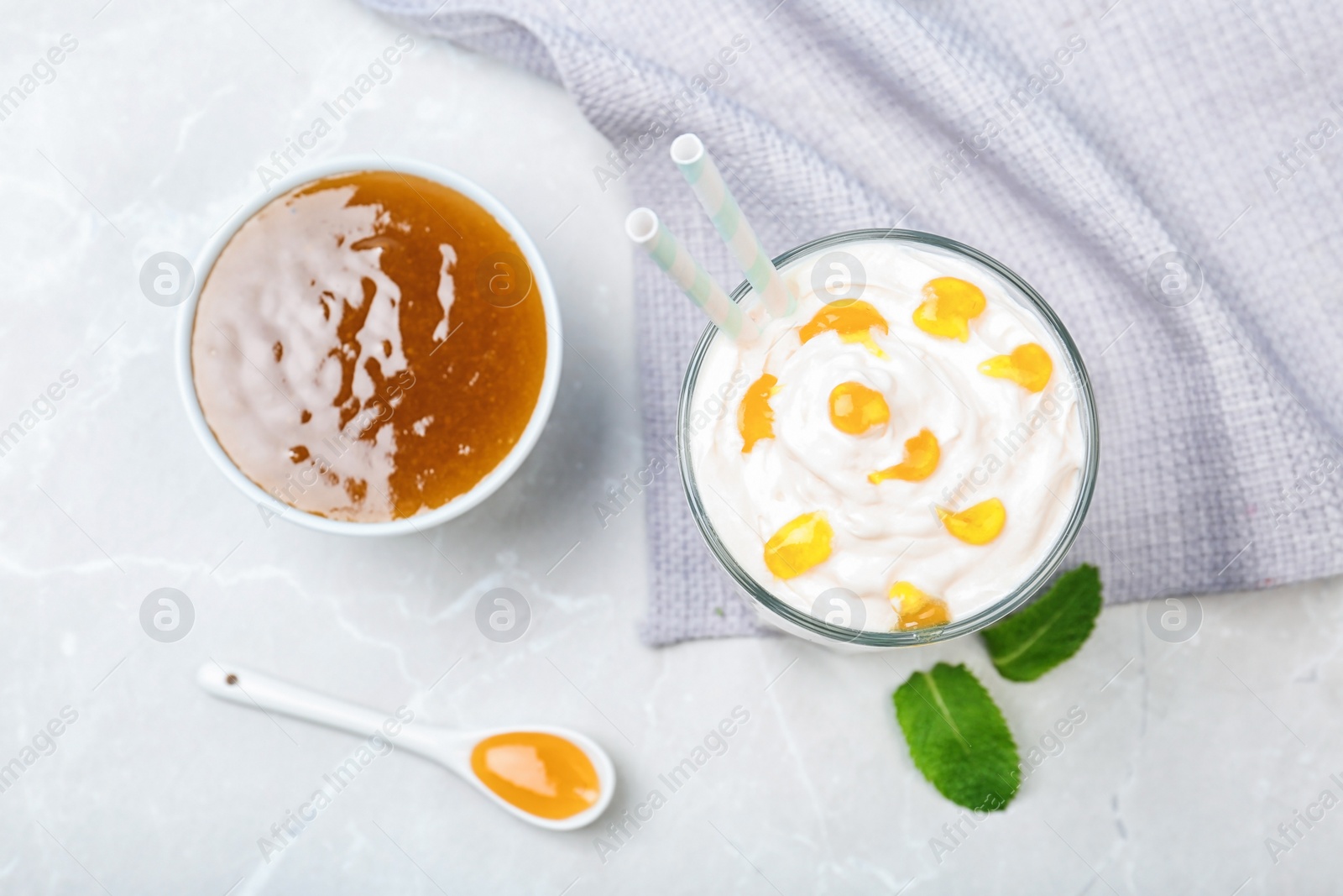 Photo of Glass with delicious milk shake on table, top view