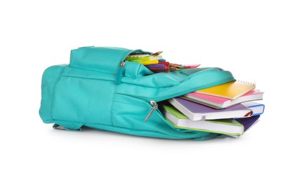 Turquoise backpack with different school supplies isolated on white