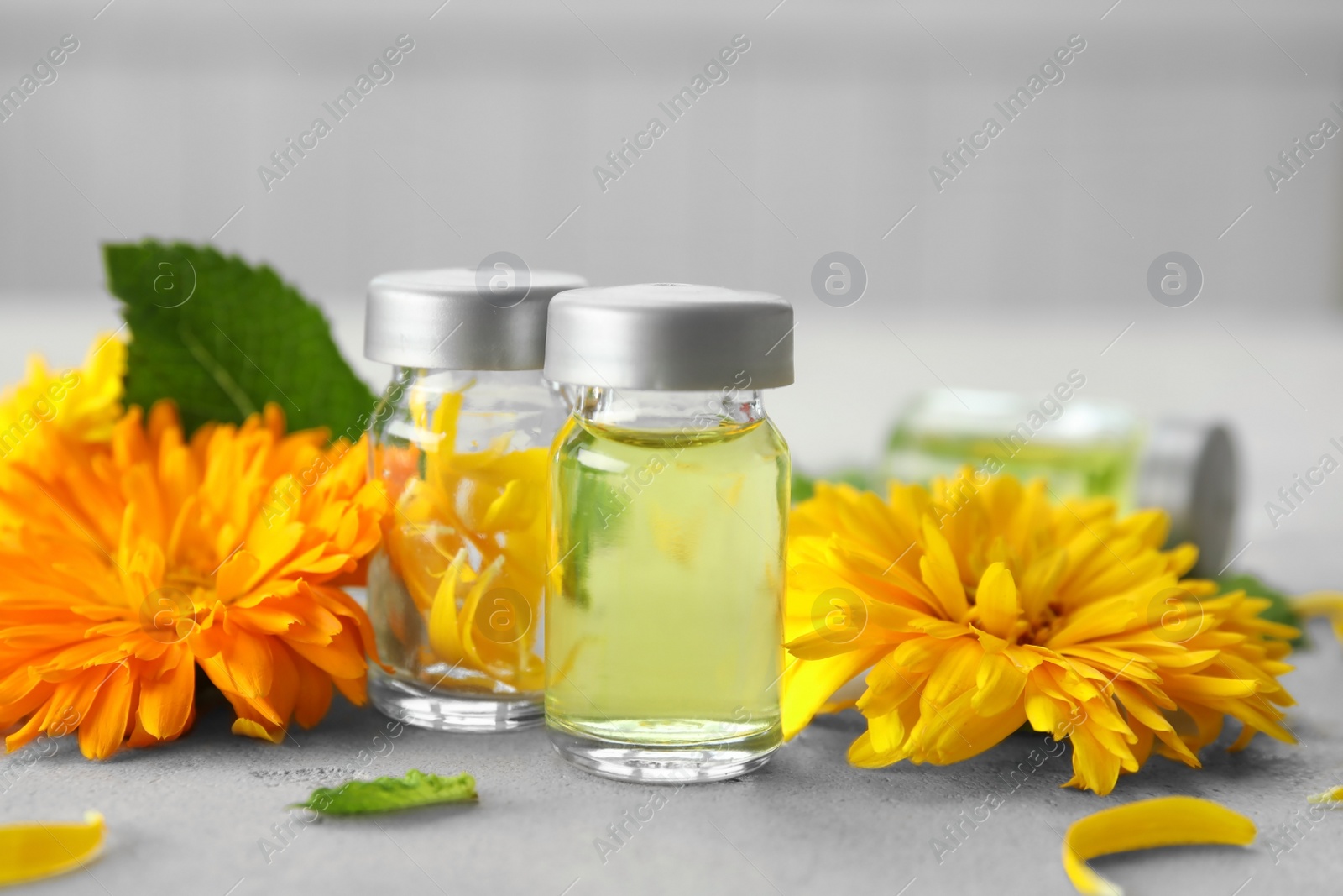 Photo of Composition with essential oils and ingredients on table