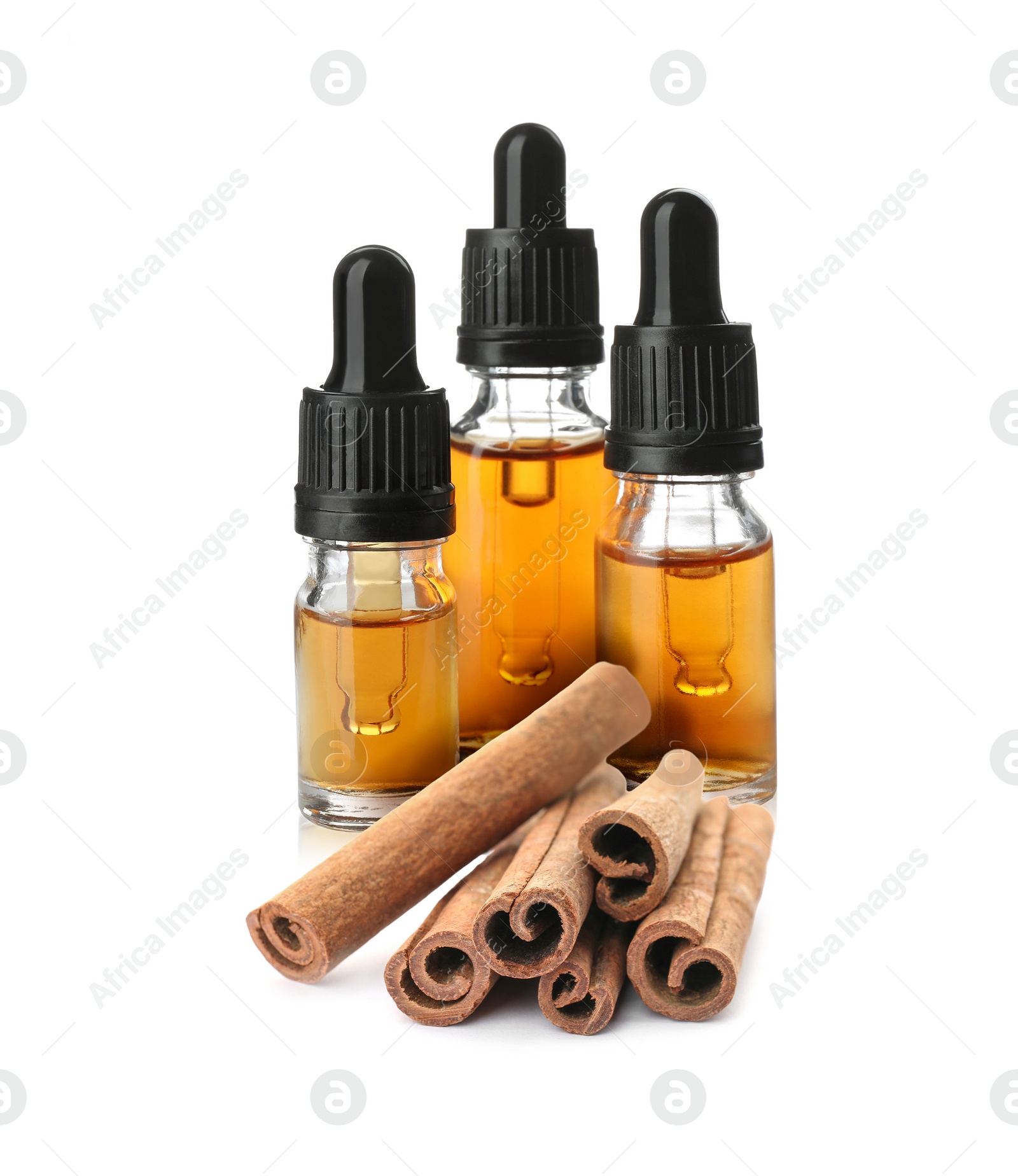 Image of Bottles of natural essential oil and dry cinnamon sticks on white background