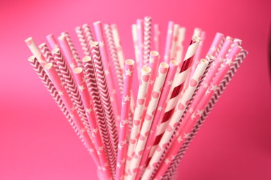 Photo of Many paper drinking straws on pink background