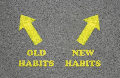 Image of Arrows with two opposite directions to Old and New Habits on asphalt, top view
