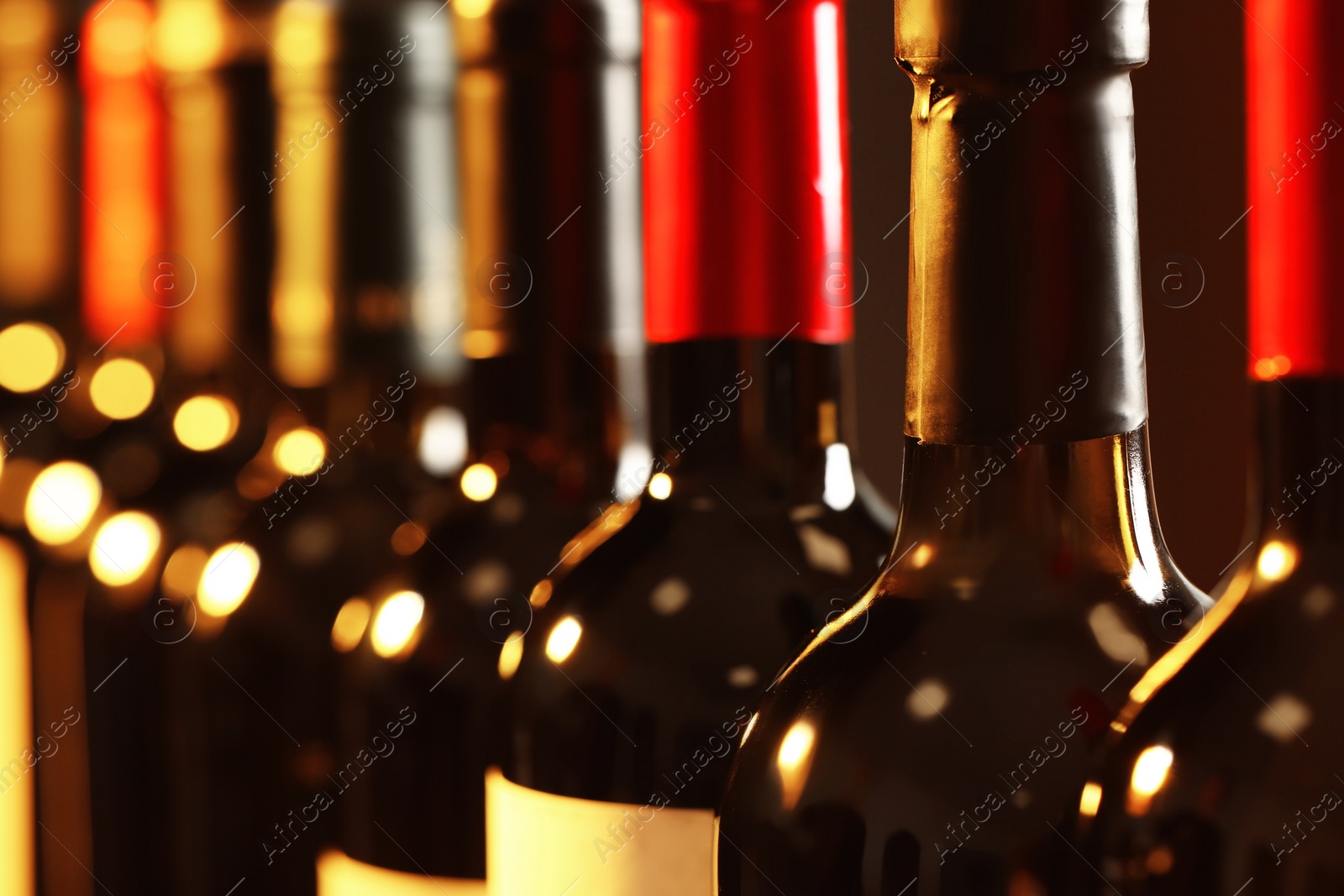 Photo of Bottles of different wines, closeup. Expensive collection