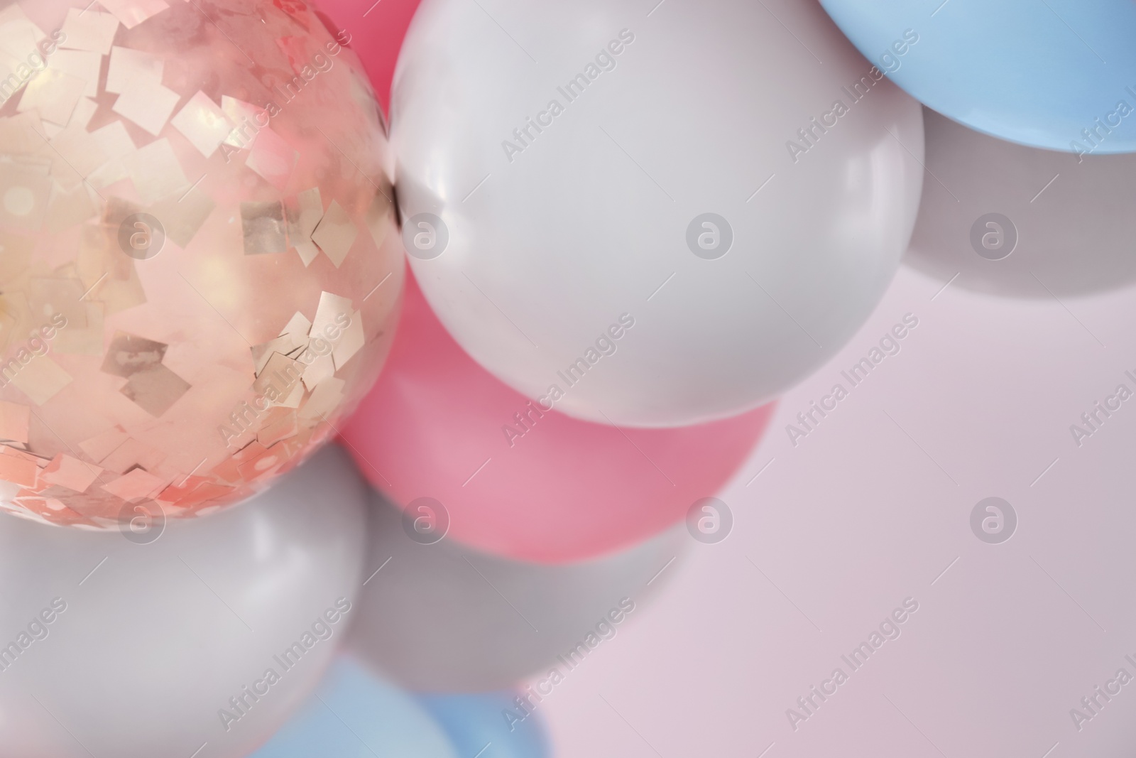 Image of Beautiful colorful balloons on light background, closeup. Party decor 