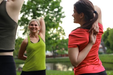 Women doing morning exercise together in park